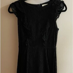 Black lace dress. Above the knee with ruffles.